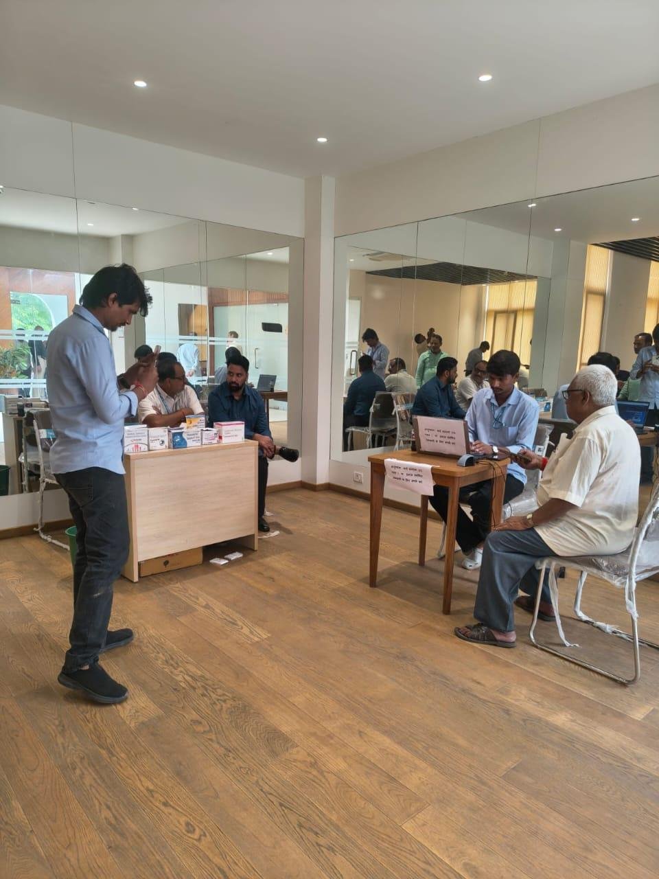 Healthcare desk setup with staff and visitors